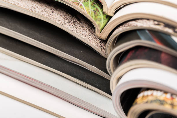 istock selective focus of the stacking magazine place on white background. Colorful abstract background 1164959305