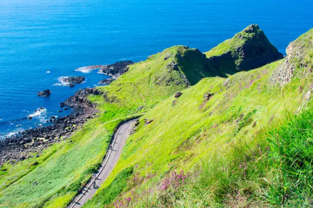 Photo of Giants Causeway Aerial view most popular and famous attraction in Northern Ireland.Hills on Coast of Atlantic ocean, summer time