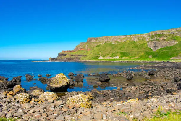 Photo of Giants Causeway Aerial view most popular and famous attraction in Northern Ireland.Hills on Coast of Atlantic ocean, summer time