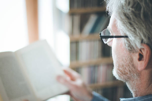 istock Senior man is reading a book at home, selective focus 1164961734