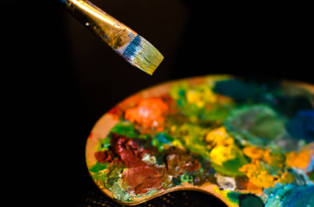 istock Palette in the process of drawing, black background 1164963628