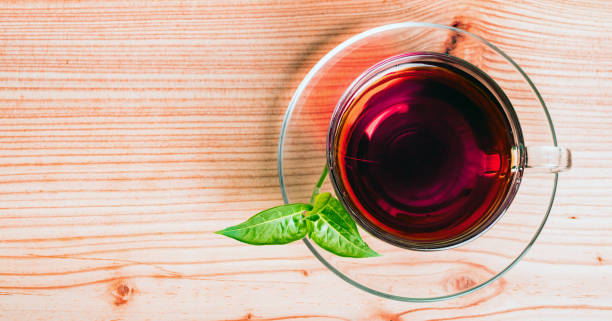 istock glass of red tea on green background 1164963999