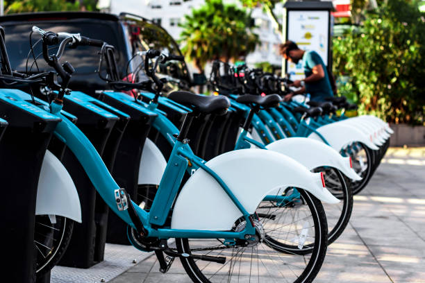 istock multiple stationed bikes for rent / someone is about to hire one. 1164965016