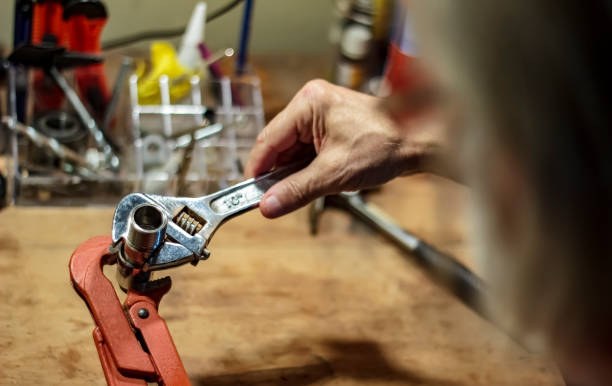 istock Male using a wrench tool to tighten a metal pipe part 1164965128