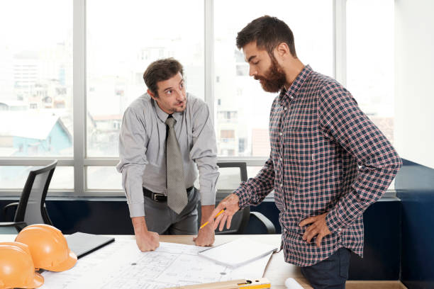 istock Business people working over blueprint 1164966603