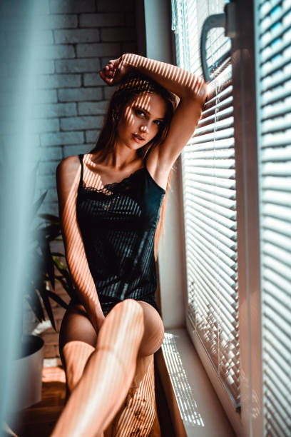 istock Female Leaning On Window While Relaxing At Home 1164967069