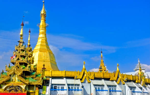 Golden Pagoda Buddhist Temple. Blue clear sky, sunny day Myanmar, Yangon - January 17, 2019: Buddhist Sule Pagoda with golden stupa, blue sky in downtown sule pagoda stock pictures, royalty-free photos & images