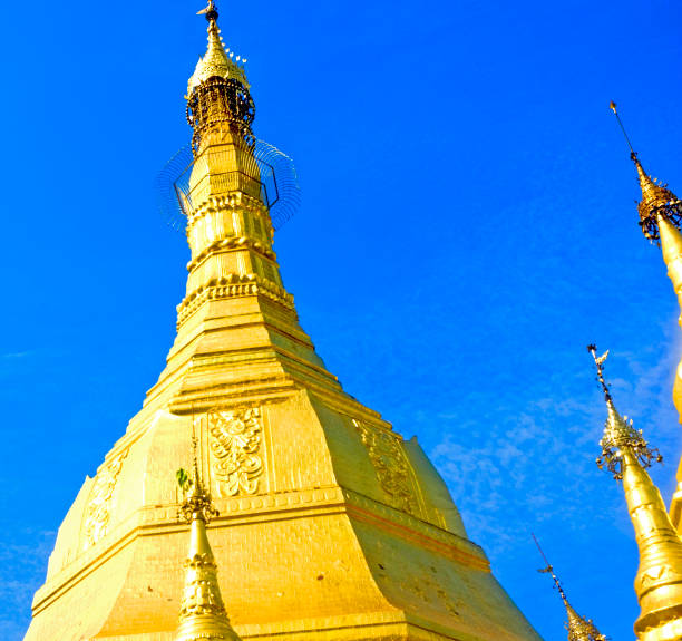 Golden Buddhist Stupa Towers with a clear blue sky. Sunny day Myanmar, Yangon - January 17, 2019: Sule Pagoda Stupa Towers in a blue sky background. sule pagoda stock pictures, royalty-free photos & images