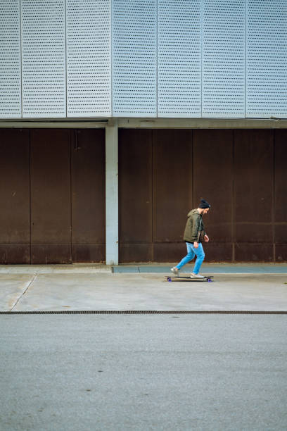 istock Man having fun with a longboard in Barcelona 1164971067