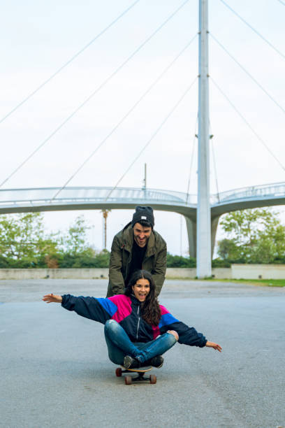 istock Having fun together with a longboard in Barcelona 1164971076