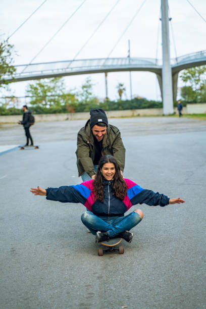 istock Having fun together with a longboard in Barcelona 1164971078