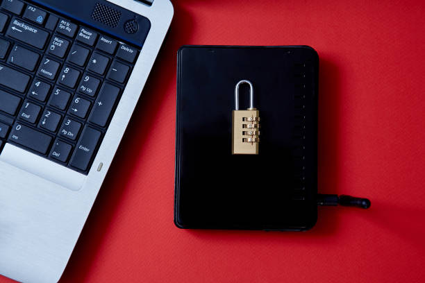 istock Computer or internet security. Data protection concept: laptop, wi-fi router and lock on red background 1164972979