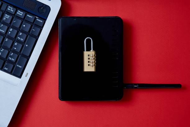 istock Computer or internet security. Data protection concept: laptop, wi-fi router and lock on red background 1164973031
