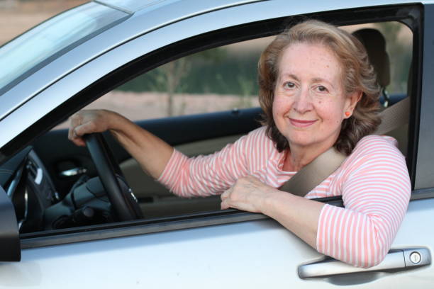istock Cute mature female driver smiling 1164976518