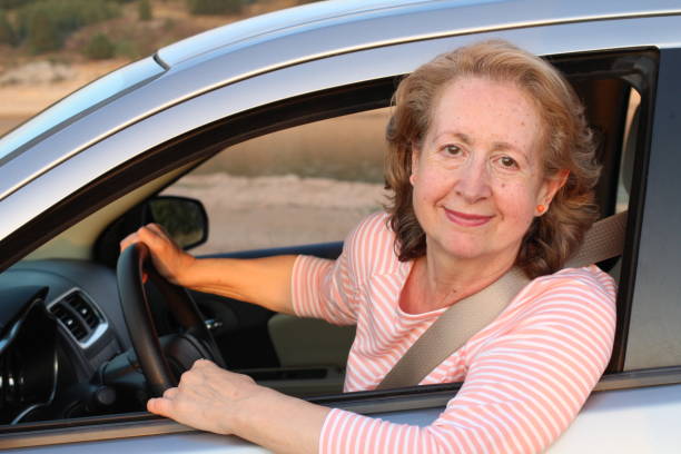 istock Cute mature female driver smiling 1164976551