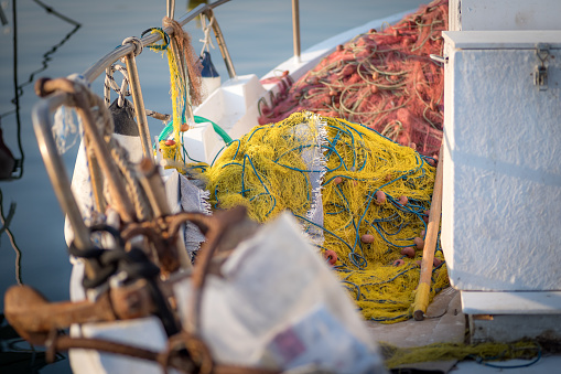 Fishing nets and tackle stored on the deck of a small inshore fishing boat.  Port Anna, Sithonia, Greece.