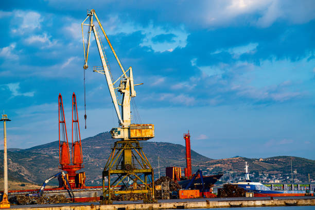 Skiathos, Greece, 02 June 2019, View of old port cranes in commercial seaport under the cloudy sky