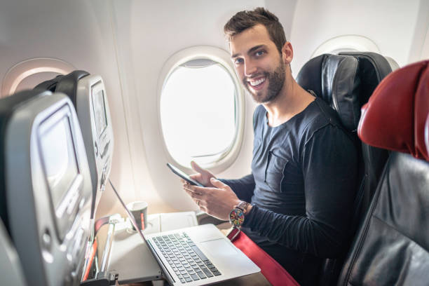 istock Portrait of man working in airplane using laptop 1164978033