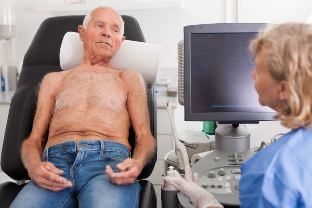 istock Doctor examines man with ultrasonic device 1164978181