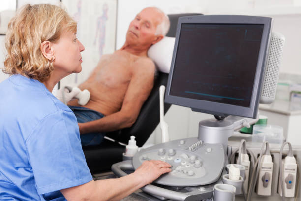 istock doctor examines a senior man  with ultrasonic  device 1164978189