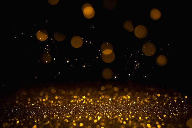 istock Golden abstract bokeh on black background. 1164978208