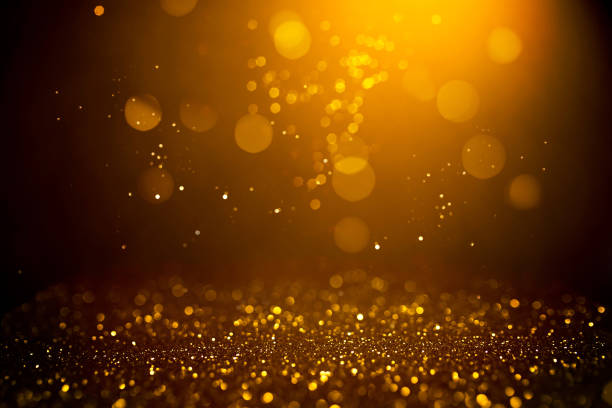 istock Golden abstract bokeh on black background. 1164978256