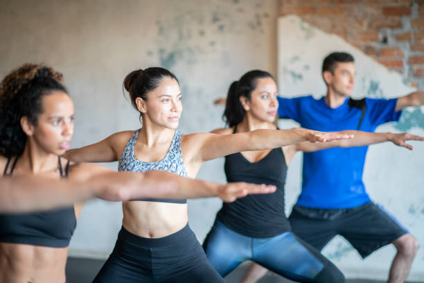 istock A group of young people in a yoga pose 1164979907