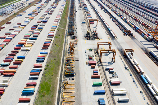 Aerial view of cargo containers and freight trains in Illinois, United States.