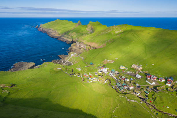 Aerial view of village at Mykines island in Faroe Islands, North Atlantic Ocean. Photo made by drone from above. Nordic natural landscape. Aerial view of village at Mykines island in Faroe Islands, North Atlantic Ocean. Photo made by drone from above. Nordic natural landscape. mykines faroe islands photos stock pictures, royalty-free photos & images