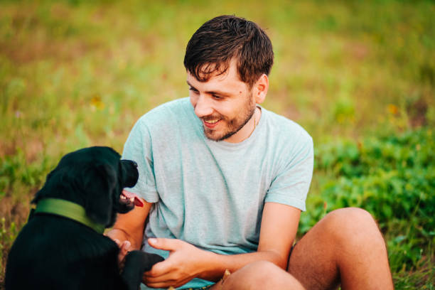 istock Guy and his dog having a fun in the nature 1164982063