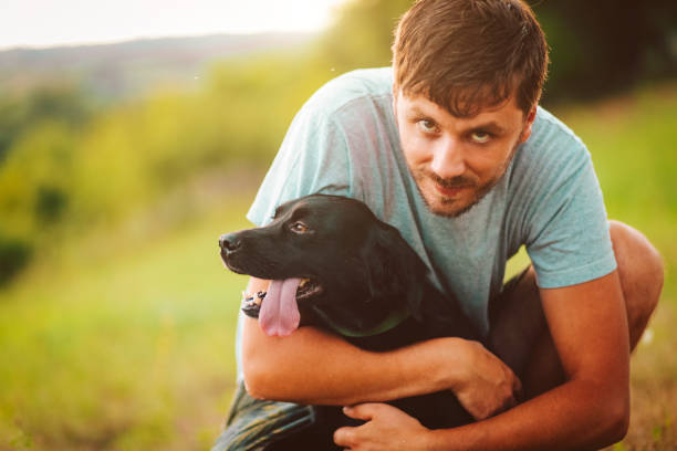 istock Guy and his dog having a fun in the nature 1164982069