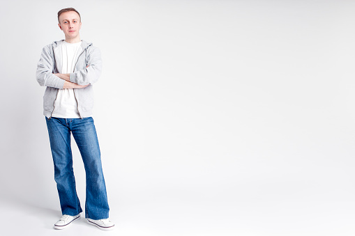 Full Length Portrait of Caucasian Man in Casual Clothing Posing Against White Background. Horizontal Image