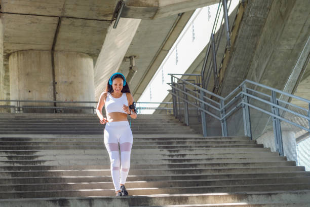 istock Sportswoman exercising on staircase 1164985295