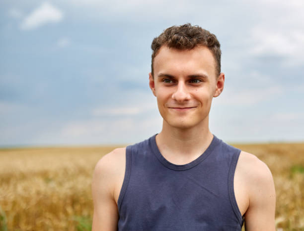 istock Young farmer in wheat field 1164989714