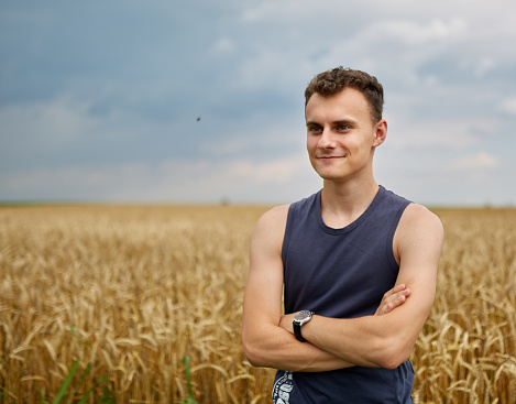 Portrait of a young farmer in a wheat field