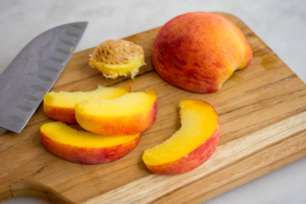 istock Slicing Peaches on a Wood Cutting Board 1164991005