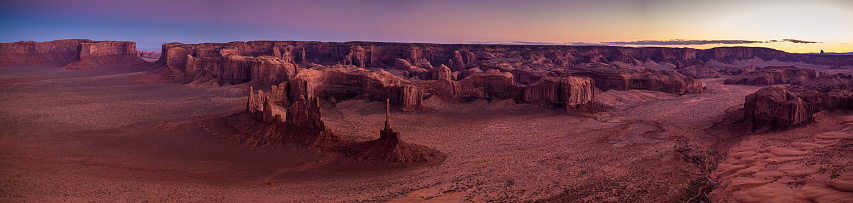 Aerial panorama of Monument Valley at sunset.