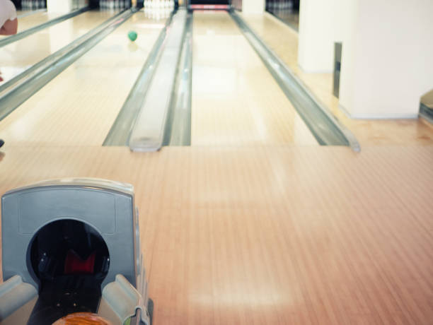 istock view on empty track at bowling club. blurred background with man throwing ball at pins 1164992720