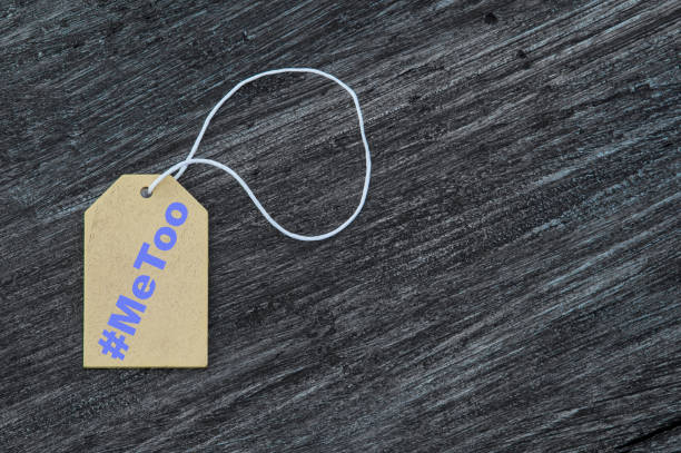 istock Blank label. With rope on wooden table. Sign that says Hashtag metoo 1164993647