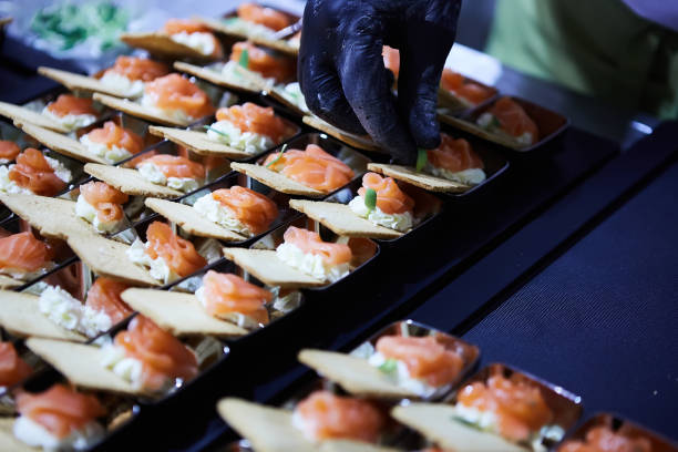 istock Chef making Norwegian Smoked Salmon Canapes with Cream Cheese. 1164994366