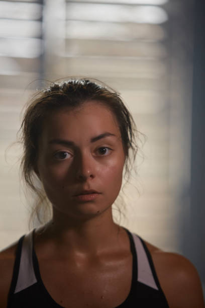 istock Sweaty Young Woman Looking at Camera 1164997182