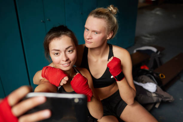 istock Female Fighters Taking Selfie 1164997230