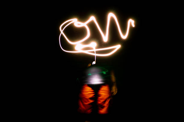 Lightpainting Young man light painting in the dark lightpainting stock pictures, royalty-free photos & images