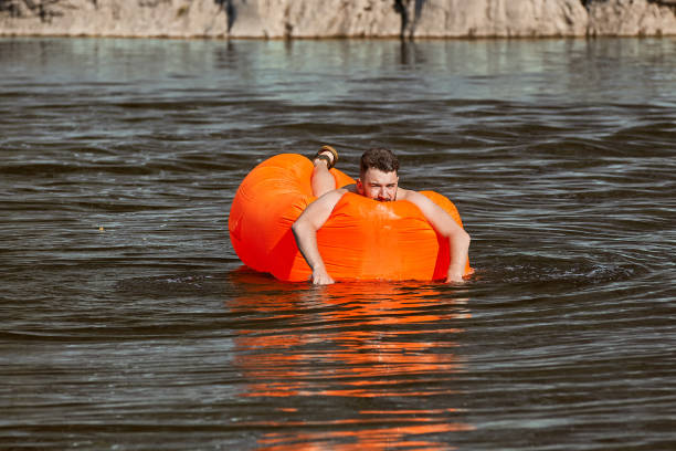 istock Caucasian man is swimming on inflatable lounger. 1165001644