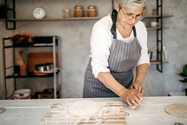 istock Senior woman baking a cake 1165004281