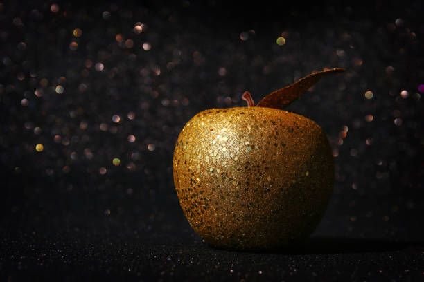 istock Rosh hashanah (jewish New Year holiday) concept. Traditional symbol, decorative glitter gold apple 1165007633