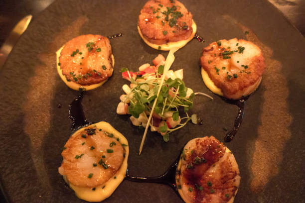 istock scallops served on dinner plate in the evening 1165009038