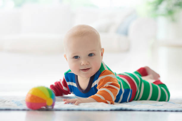 istock Baby boy with toys and ball 1165009968