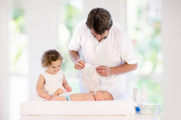 father changing diaper to baby boy. dad and child. - 18812 imagens e fotografias de stock