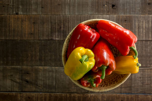 istock Sweet peppers in basket with wooden table 1165011968